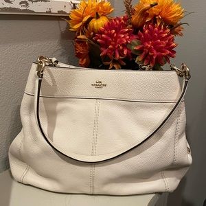 Off white pebble leather.  Center zip compartment. Style F28997. Snap closure.